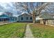 Landscaped backyard with a spacious lawn and a walkway at 385 S Arlington Ave, Indianapolis, IN 46219
