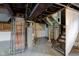 Unfinished basement with exposed utilities and concrete floor at 385 S Arlington Ave, Indianapolis, IN 46219