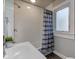 Clean bathroom with white subway tiles, gray accents, and a striped shower curtain at 385 S Arlington Ave, Indianapolis, IN 46219