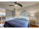 Bedroom with hardwood floors, a view of the dining area, and ceiling fan at 385 S Arlington Ave, Indianapolis, IN 46219