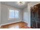 Simple bedroom with hardwood floors and a large window at 385 S Arlington Ave, Indianapolis, IN 46219