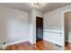 Empty bedroom with hardwood floors, floating shelves, and a closet at 385 S Arlington Ave, Indianapolis, IN 46219
