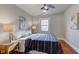Bright bedroom with hardwood floors, ceiling fan, and window at 385 S Arlington Ave, Indianapolis, IN 46219