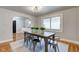 Bright dining room with farmhouse table and hardwood floors at 385 S Arlington Ave, Indianapolis, IN 46219