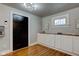 Entryway with hardwood floors, white cabinets, and black door at 385 S Arlington Ave, Indianapolis, IN 46219