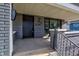 Black front door and brick porch with metal railing at 385 S Arlington Ave, Indianapolis, IN 46219