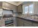 Modern gas range, gray cabinets, and updated countertops at 385 S Arlington Ave, Indianapolis, IN 46219
