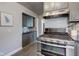 Stainless steel appliances and gray cabinets in a galley kitchen at 385 S Arlington Ave, Indianapolis, IN 46219