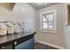 Bright laundry room with a window and built-in shelving at 385 S Arlington Ave, Indianapolis, IN 46219