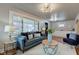 Bright living room features stylish sofas, a coffee table, and a large window at 385 S Arlington Ave, Indianapolis, IN 46219