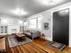 Bright living room with hardwood floors, fireplace, and built-in shelving at 385 S Arlington Ave, Indianapolis, IN 46219