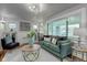 Living room with hardwood floors, gray walls, and green sofa at 385 S Arlington Ave, Indianapolis, IN 46219