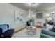 Living room with a fireplace, large artwork, and comfortable seating at 385 S Arlington Ave, Indianapolis, IN 46219