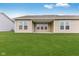 Covered patio with grassy backyard and tan siding at 2081 Covey Dr, Danville, IN 46122