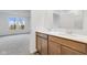 Double vanity bathroom with wood cabinets and a view of a bedroom at 2081 Covey Dr, Danville, IN 46122