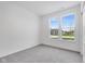Bright bedroom with grey carpet and a view of the neighborhood at 2081 Covey Dr, Danville, IN 46122
