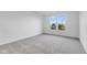 Bright bedroom with gray carpeting and a large window offering natural light at 2081 Covey Dr, Danville, IN 46122