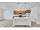 Modern kitchen with wood cabinets, white countertops, and stainless steel appliances at 2081 Covey Dr, Danville, IN 46122