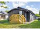 Dark-painted bungalow with a new deck and landscaping at 1215 N Gladstone Ave, Indianapolis, IN 46201