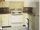 Small kitchen features white cabinets and appliances at 1108 Burdsal Pkwy, Indianapolis, IN 46208