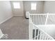Spacious loft area with gray carpeting and white railing at 10257 Meadow Path Ln, Indianapolis, IN 46239