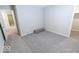 Bright bedroom featuring grey carpet and access to hallway at 10257 Meadow Path Ln, Indianapolis, IN 46239