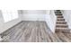 Gray wood-look floors and white wainscoting at 10257 Meadow Path Ln, Indianapolis, IN 46239