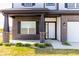 Brick house exterior with a white front door and a covered porch at 10257 Meadow Path Ln, Indianapolis, IN 46239