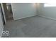 Grey carpeted bedroom with access to another room at 10257 Meadow Path Ln, Indianapolis, IN 46239