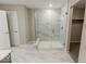 Walk-in shower with marble tile and glass enclosure at 10257 Meadow Path Ln, Indianapolis, IN 46239