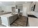 Kitchen island with double sink, gray cabinets, and quartz countertops at 10257 Meadow Path Ln, Indianapolis, IN 46239