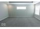 Spacious main bedroom with grey carpet and a window at 10257 Meadow Path Ln, Indianapolis, IN 46239