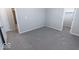 Bright bedroom with gray carpet, neutral walls, and doors to closet and bath at 10257 Meadow Path Ln, Indianapolis, IN 46239