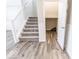 Modern staircase with gray carpeting and storage area at 10257 Meadow Path Ln, Indianapolis, IN 46239