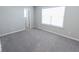 Spacious bedroom with gray carpet and large window at 10257 Meadow Path Ln, Indianapolis, IN 46239