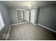 Well-lit bedroom featuring gray walls and wood-look vinyl flooring at 905 Crescent Dr, Anderson, IN 46013