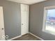 Bedroom with gray walls, vinyl flooring, and built-in storage at 905 Crescent Dr, Anderson, IN 46013