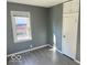 Cozy bedroom with gray walls, vinyl flooring, and built-in storage at 905 Crescent Dr, Anderson, IN 46013