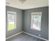 Well-lit bedroom with gray walls and vinyl flooring at 905 Crescent Dr, Anderson, IN 46013