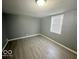 Bright bedroom with gray walls and wood-look flooring at 905 Crescent Dr, Anderson, IN 46013
