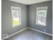 Well-lit bedroom with gray walls and vinyl flooring at 905 Crescent Dr, Anderson, IN 46013