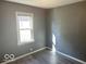 Simple bedroom with gray walls and vinyl flooring at 905 Crescent Dr, Anderson, IN 46013