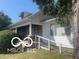 Ranch style home with a covered porch and attached ramp at 1108 Burdsal Pkwy, Indianapolis, IN 46208
