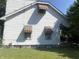 White sided home with brown awnings and a well maintained lawn at 1108 Burdsal Pkwy, Indianapolis, IN 46208