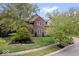 Brick two-story house with a manicured lawn and landscaping at 8418 Mesic Ct, Indianapolis, IN 46278