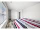 Bedroom with wood-look floors, striped bedding, and built-in shelves at 2900 Lakestream Dr, Columbus, IN 47201