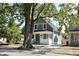 Renovated gray house with large tree and driveway at 3131 Boulevard Pl, Indianapolis, IN 46208