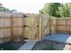 Newly fenced backyard with gate and gravel area at 3131 Boulevard Pl, Indianapolis, IN 46208