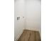 Empty laundry room with light walls and wood-look flooring at 3131 Boulevard Pl, Indianapolis, IN 46208
