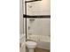 Bathroom with a white toilet and bathtub with glass enclosure at 3131 Boulevard Pl, Indianapolis, IN 46208